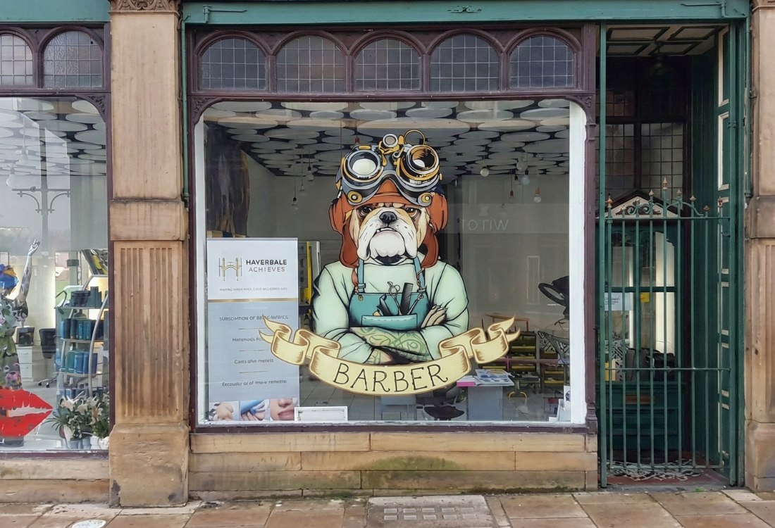 Intricate bulldog vinyl decal on a barbershop window, demonstrating the precision of a Graphtec cutter in a professional print workflow. 