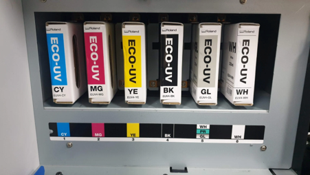 Roland Eco-UV ink cartridges illustrating UV printing in a solvent vs UV printing comparison. 