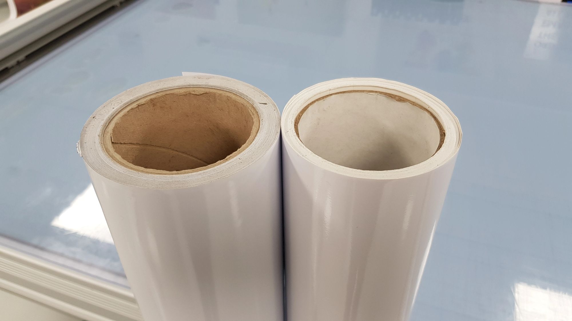 Two different rolls of vinyl stacked next to each other. 