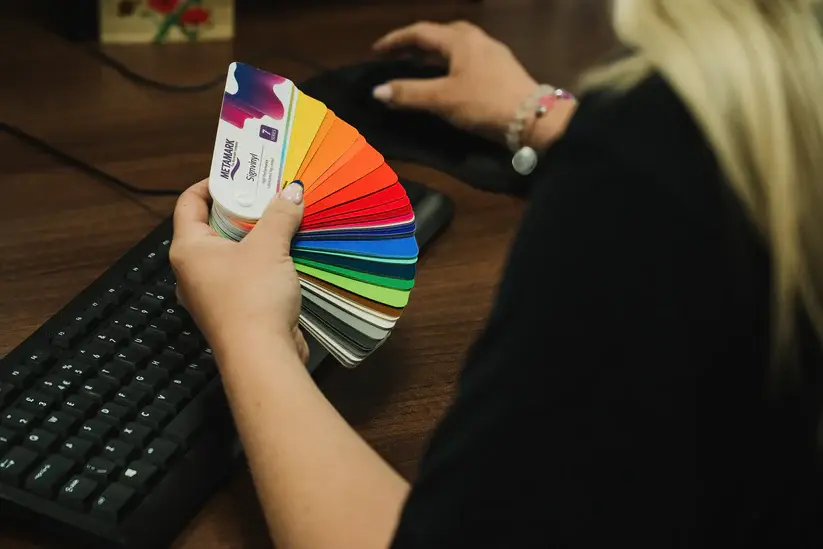 A woman holding Metamark vinyl supplies to help her choose the right one for her sign making application. 