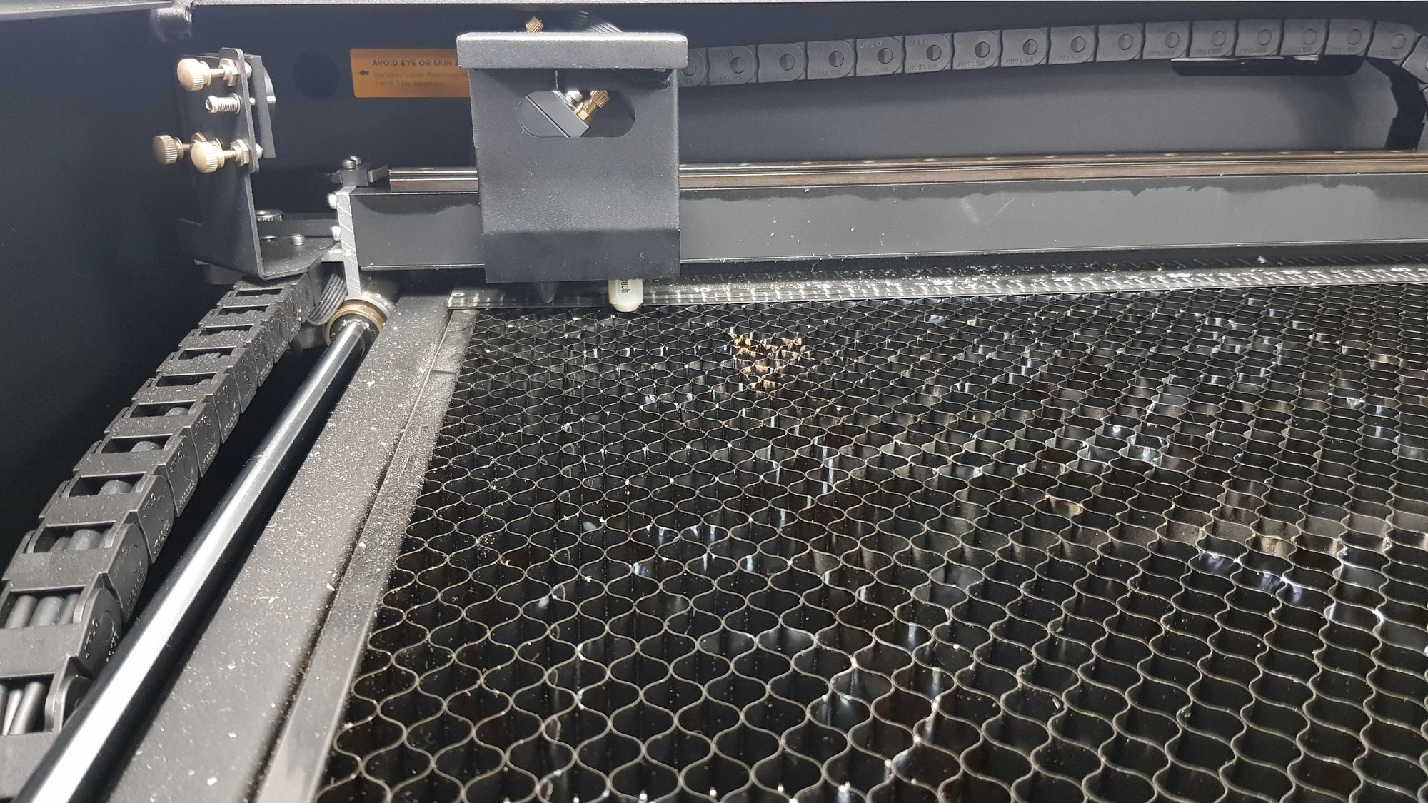 A close up of a laser cutting machine showing how it can be maintained.
